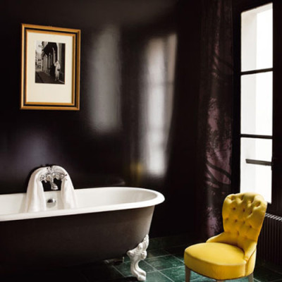 Black bathroom with yellow chair